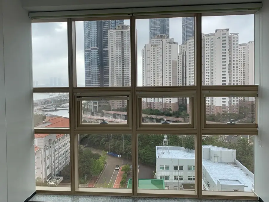 부산 대학교 강의동 통유리로 보이는 고층 빌딩과 강변 전경