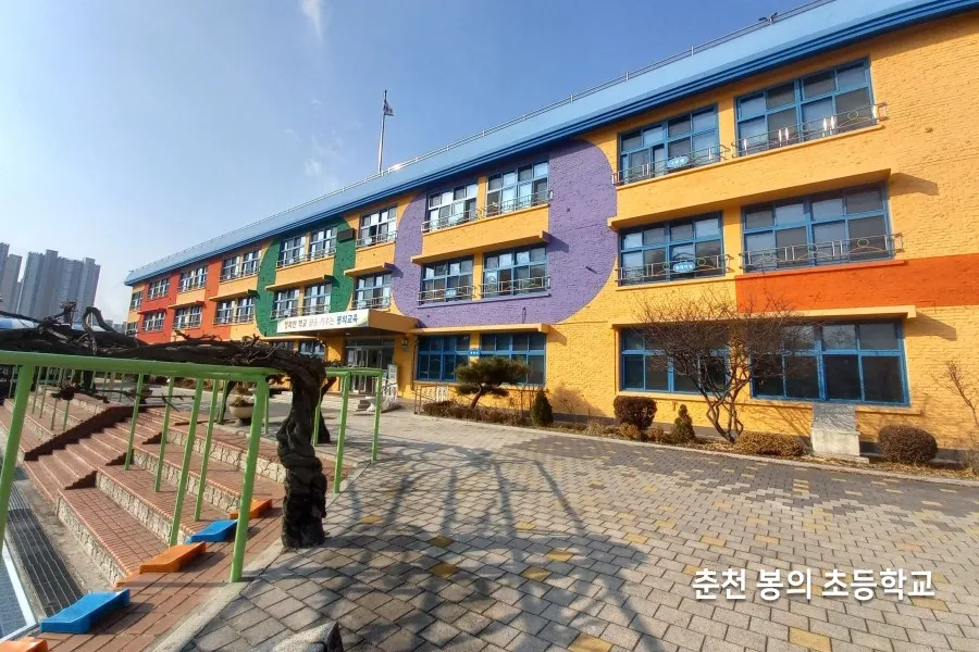초등학교 건물 외관과 운동장이 보이는 교사동 전경